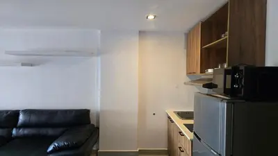 a living room with a couch and a microwave at The Chalong Pearl 1BR T1-703 in Phuket Town