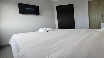 a bedroom with a white bed with towels on it at The Chalong Pearl 1BR T1-703 in Phuket Town