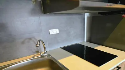 a kitchen with a sink and a counter top at The Chalong Pearl 1BR T1-703 in Phuket Town