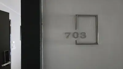 a door with a clock on the side of it at The Chalong Pearl 1BR T1-703 in Phuket Town