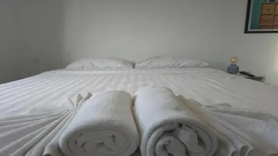a bed with two towels on top of it at Urban loft 1BR T1-706 in Chalong