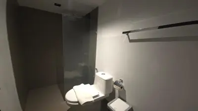 a bathroom with a toilet and a glass shower at Urban loft 1BR T1-706 in Chalong