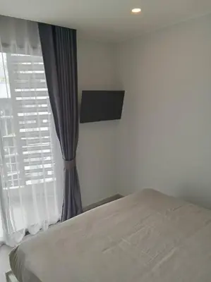 a bedroom with a bed and a window at Contemporary 1BR Condo - NV-724 in Phuket Town