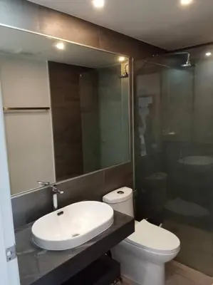 a bathroom with a toilet and a sink and a mirror at Contemporary 1BR Condo - NV-724 in Phuket Town