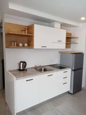 a white kitchen with a sink and a stove at Contemporary 1BR Condo - NV-724 in Phuket Town
