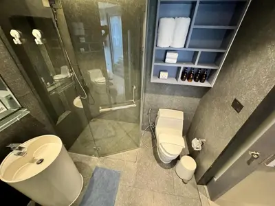 a bathroom with a shower and a toilet and a sink at 1BDR Rooftop bar The biggest gym Spa centre in Kamala Beach