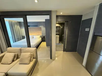 a living room with a couch and a bed at 1BDR Rooftop bar The biggest gym Spa centre in Kamala Beach