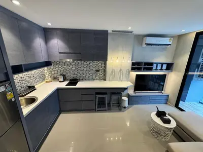 a kitchen with a sink and a counter top at 1BDR Rooftop bar The biggest gym Spa centre in Kamala Beach