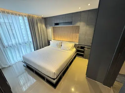 a bedroom with a bed and a large window at 1BDR Roof pool 500m to beach Great gym Parking in Kamala Beach
