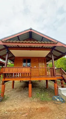 a large wooden house with a large deck at Cheriya bungalow Kohyaonoi in Ban Laem Sai