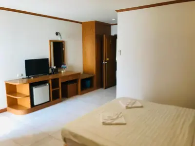 a hotel room with a bed and a television at Global Hotel Beach View in Patong Beach