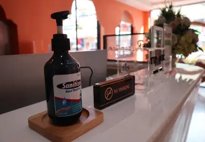a bottle of sauce sitting on top of a counter at Khaleej Mass Hotel Patong in Patong Beach