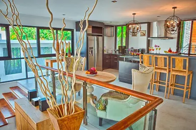 a kitchen and living room with a table and chairs at Fully Serviced Grand Villa Luxury Time Phuket in Bang Tao Beach
