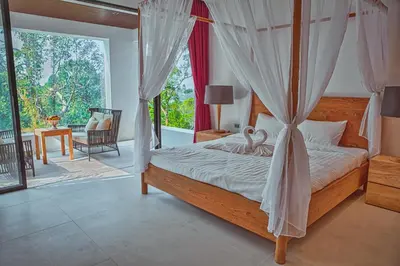 a bedroom with a bed with a mosquito net at Fully Serviced Grand Villa Luxury Time Phuket in Bang Tao Beach