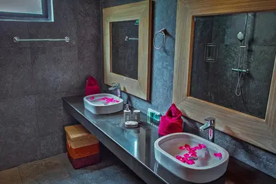 a bathroom with two sinks and a tub with pink decorations at Fully Serviced Grand Villa Luxury Time Phuket in Bang Tao Beach