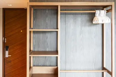 a closet with wooden shelves and a door at Studio Aurel 1BRTropical ViewsShuttle to NaiHarn in Rawai Beach