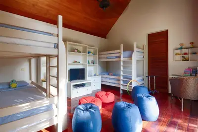 a bedroom with two bunk beds and blue bean bags at Villa Ananda at Jivana Beach Villas in Pilai Beach