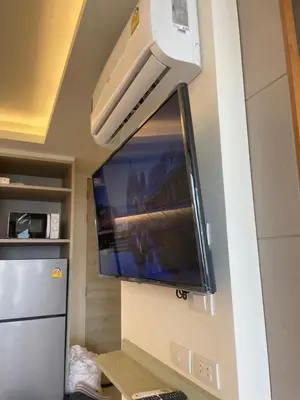a flat screen tv hanging on a wall at Cozy corner in Ao Nang Beach