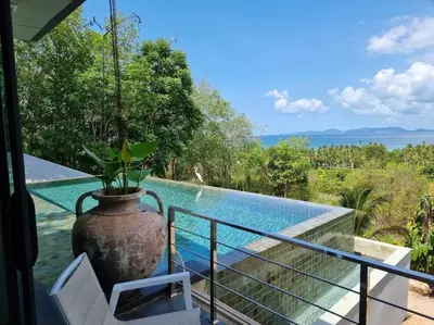 a large vase sitting on a balcony next to a pool at Krabi Glass House Sea View Villa in Tab Kaek Beach