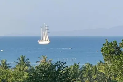 a sail boat floating in the water with trees at Krabi Glass House Sea View Villa in Tab Kaek Beach