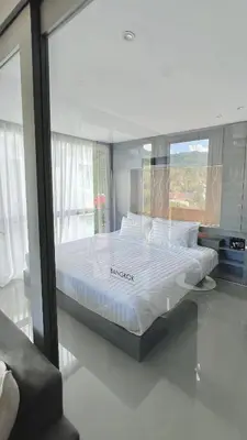 a large bed in a room with a window at AdWords Mountain View CityGate Kamala in Phuket Town