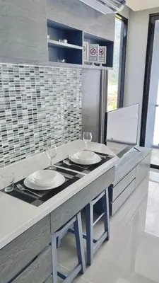 a kitchen with two wine glasses on a counter at AdWords Mountain View CityGate Kamala in Phuket Town