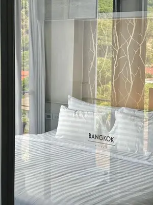a bedroom with a bed with a sign on it at AdWords Mountain View CityGate Kamala in Phuket Town