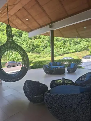 a patio with couches and chairs under a canopy at Veloche Karon 12 in Karon Beach