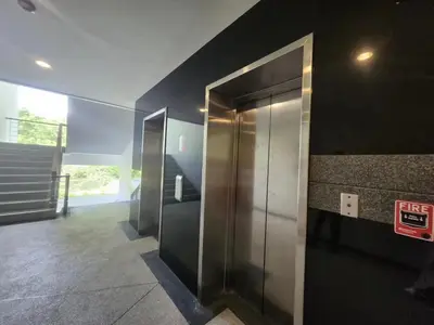 a hallway with elevators in a building at Veloche Karon 12 in Karon Beach