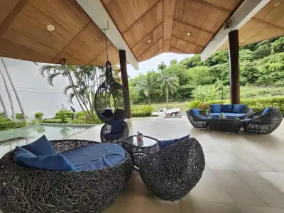 a patio with three chairs and a swing at Veloche Karon 12 in Karon Beach