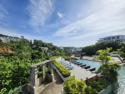 an aerial view of a resort swimming pool with chairs and trees at Veloche Karon 12 in Karon Beach