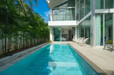 a swimming pool in front of a house at Spacious 4BR Pool Villa at Grand View in Bangtao in Bang Tao Beach