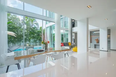 an open living room with a dining table and chairs at Spacious 4BR Pool Villa at Grand View in Bangtao in Bang Tao Beach