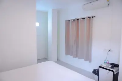 a white room with a bed and a shower at XX BAO Pathong Beach เบา ป่าตอง บีช in Patong Beach