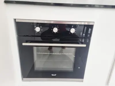 a black oven with its door open in a kitchen at Sanook villas Nai Harn beach in Rawai Beach