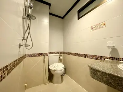 a bathroom with a shower and a toilet at Lucky Residence Patong in Patong Beach