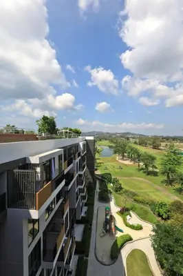 an apartment building with a view of a golf course at Sky Park condo 1 bedroom in Laguna Phuket