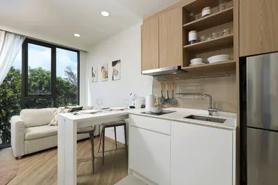 a white kitchen with a counter and a sink at Sky Park condo 1 bedroom in Laguna Phuket