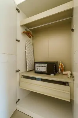 a microwave sitting on a shelf in a kitchen at Cosy 1 bedroom Chic condo in Karon Beach