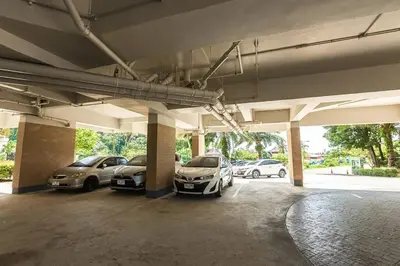 a parking lot with several cars parked in it at Cosy 1 bedroom Chic condo in Karon Beach