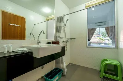a bathroom with a sink and a mirror and a shower at Cosy 1 bedroom Chic condo in Karon Beach