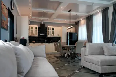 a living room and kitchen with a couch and a table at Phuket Villa Sofia in Ban Phak Chit