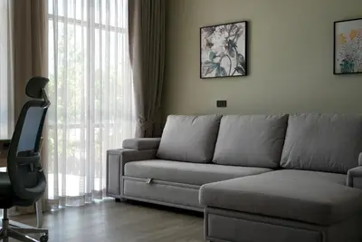 a living room with a couch and a chair at Phuket Villa Sofia in Ban Phak Chit