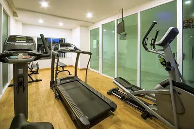 a gym with several tread machines in a room at Cozy apartment at peaceful Rawai Condo in Rawai Beach