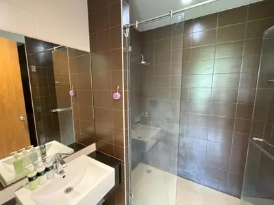 a bathroom with a shower and a sink and a shower at Cozy apartment at peaceful Rawai Condo in Rawai Beach