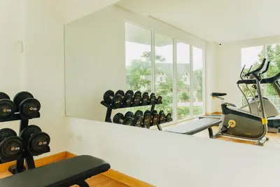 a gym with a large mirror and a bunch of machines at Cozy apartment at peaceful Rawai Condo in Rawai Beach