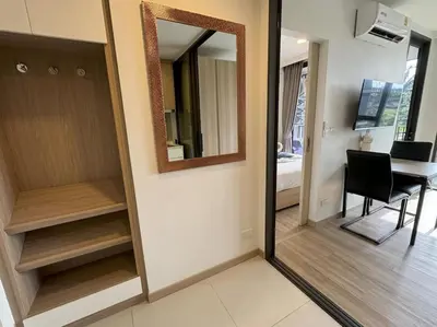 a room with a mirror and a table and a desk at Modern Laguna Skypark apartments by Lofty in Bang Tao Beach
