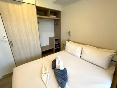 a bedroom with a bed with two towels on it at Modern Laguna Skypark apartments by Lofty in Bang Tao Beach