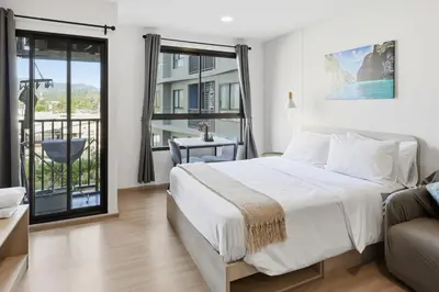 a bedroom with a bed and a balcony at Dcondo Reef Modern Condos 1&2 Bedrooms in Kathu