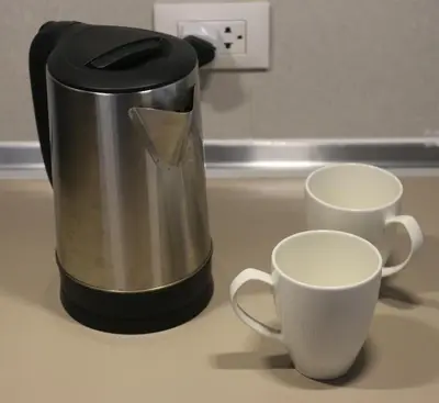 a coffee maker sitting next to two cups on a counter at Dcondo Reef Modern Condos 1&2 Bedrooms in Kathu
